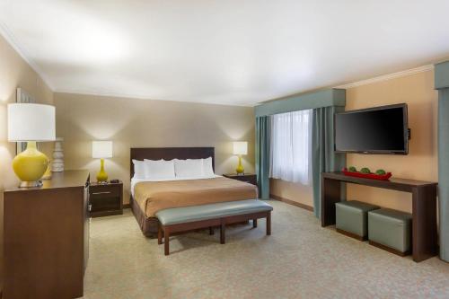 a hotel room with a bed and a flat screen tv at Quality Inn Payson I-15 in Payson