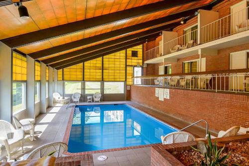 a swimming pool in a building with a brick wall at Clarion Inn Harpers Ferry-Charles Town in Harpers Ferry