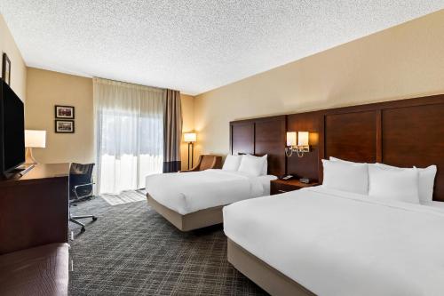 a hotel room with two beds and a television at Comfort Inn Roswell-Dunwoody in Roswell