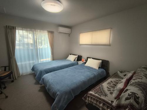a room with two beds and a window at 北滨Grace DAY 101 in Takamatsu
