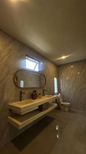 a bathroom with a sink and a mirror on the wall at Star Bar and Bungalows in Gili Islands