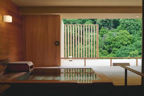 a room with a large window in a building at Hakone Pax Yoshino in Hakone