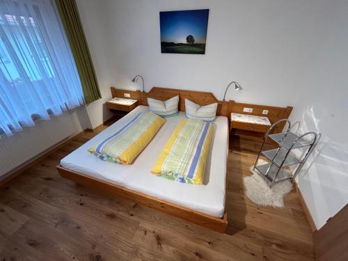 a bedroom with a large bed in a room at Allgaeuer-Landhaus-Stocker in Hopferau