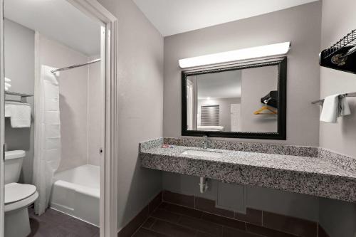 a bathroom with a sink and a mirror at Econo Lodge Inn & Suites Laredo - Nuevo Laredo in Laredo