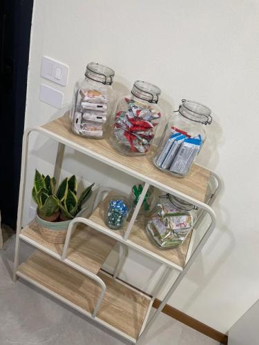 a shelf in a refrigerator with jars and a plant at Il Piccolo Scrigno 2 in Lonigo