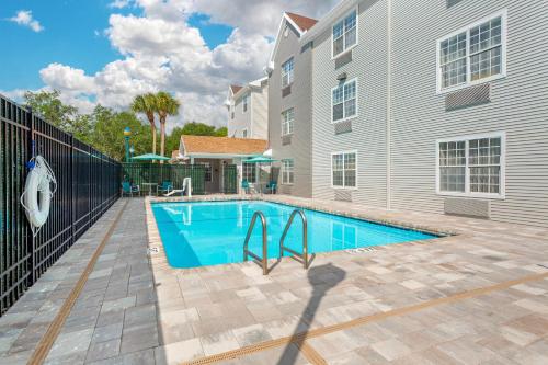 a swimming pool in front of a building at MainStay Suites Tampa Moffitt-USF in Tampa