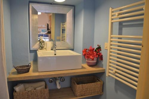a bathroom with a sink and a mirror at Dammuso La Ginestra in Pantelleria