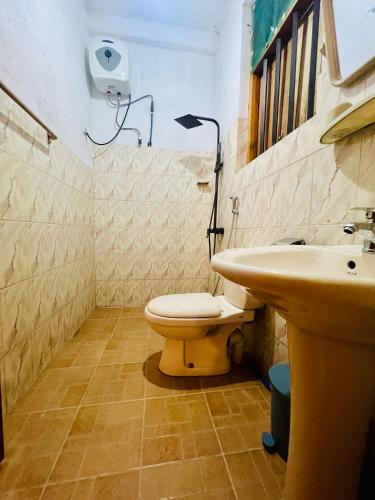 a bathroom with a toilet and a sink at Velora Villa Tangalle in Tangalle
