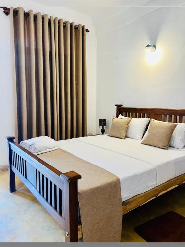 a bedroom with two beds and a radiator at Velora Villa Tangalle in Tangalle