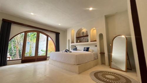 a bedroom with a large bed and a large window at Star Bar and Bungalows in Gili Islands