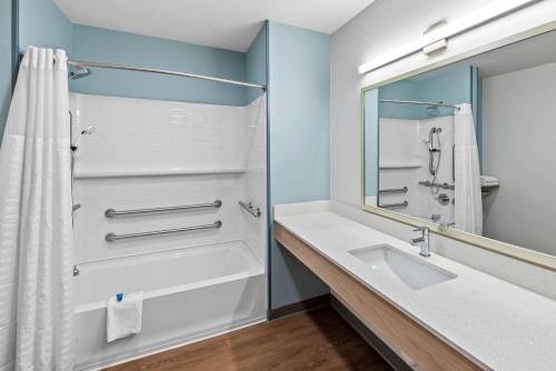 a bathroom with a sink and a mirror at WoodSpring Suites Santee - San Diego Northeast in Santee