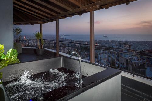 a kitchen sink with a view of the city at Palazzo Vista Suite&Spa in Thessaloniki