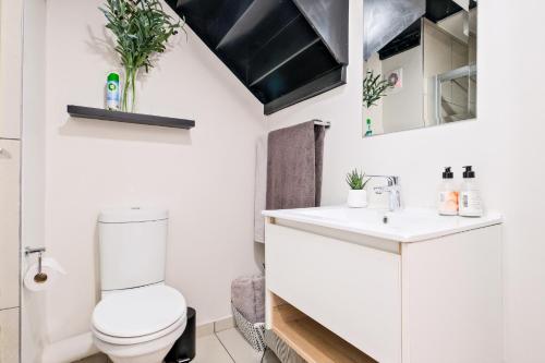 a bathroom with a toilet and a sink at SoftPod Loft in Prime Location Fourways in Sandton