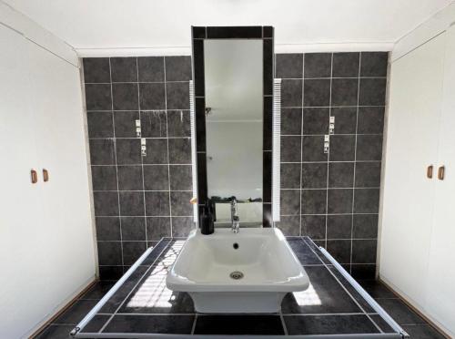 a bathroom with a sink and a mirror at One Birdswood in Richards Bay