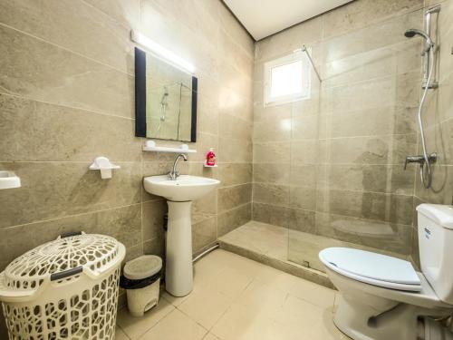 a bathroom with a toilet and a sink and a shower at Lafayette Central Apartment-Tunis in Tunis
