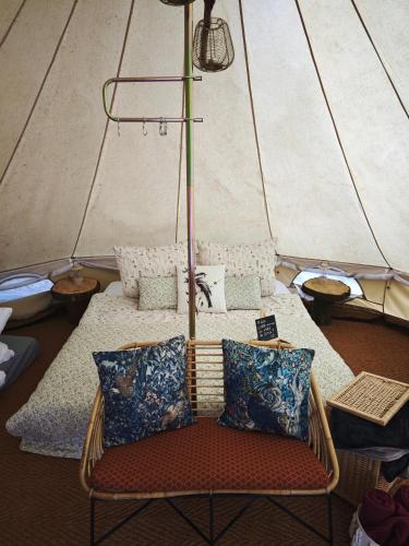 a wicker chair sitting in front of a tent at Whispering Pines in Altsorgefeld