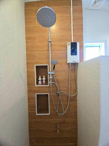 a shower with a shower head in a bathroom at Chortip House in Pai