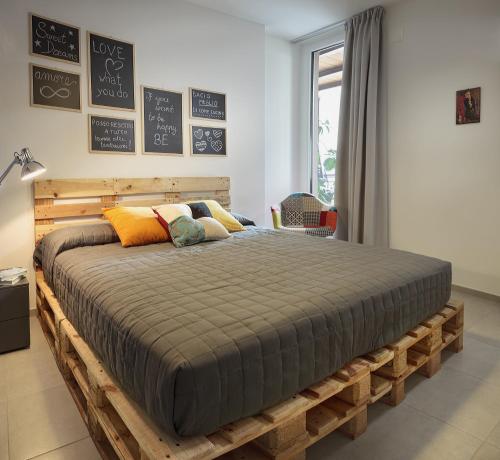 a bedroom with a wooden bed in a room at Rivetto Suites in Alba