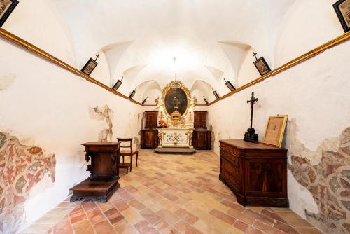 a room with a church with a cross on the wall at Palazzo Sbaraglini in Assisi