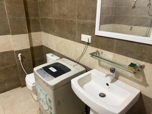 a bathroom with a sink and a toilet at Palm Breeze Kokuvil G1 in Jaffna