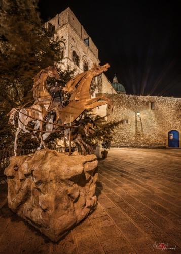 a sculpture of a horse on a rock in front of a building at Al Centro in Gangi