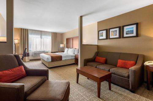 a hotel room with a bed and a living room at Comfort Inn & Suites Murrieta Temecula Wine Country in Murrieta