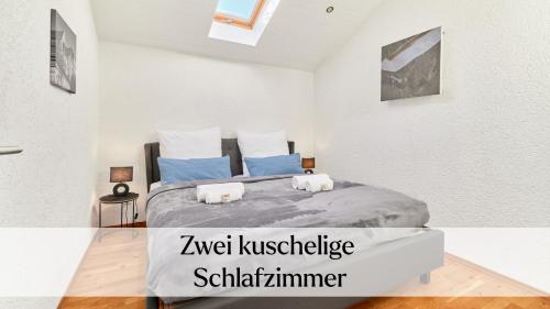 a bedroom with a large bed with blue pillows at Traumferienwohnung Domblick - Parkplatz inklusive, zentral mit Altstadtblick & Netflix in Limburg an der Lahn