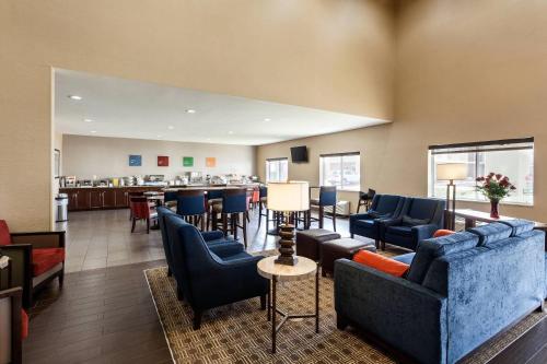 a lobby with couches and a bar in the background at Comfort Suites Lincoln North in Lincoln