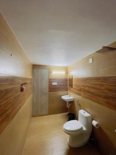 a bathroom with a toilet and a sink at RiverSoul Pool Villa in North Paravur