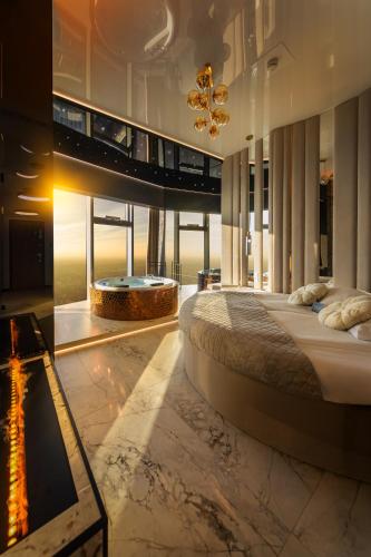a bedroom with a large bed and a fireplace at Sky Tower Apartamenty - In The Sky Apartments in Wrocław