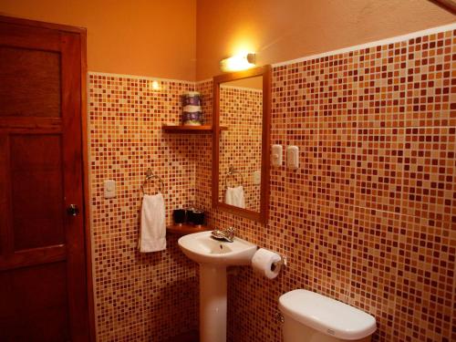 a bathroom with a sink and a toilet at El Encanto Garden Hotel in Santa Cruz