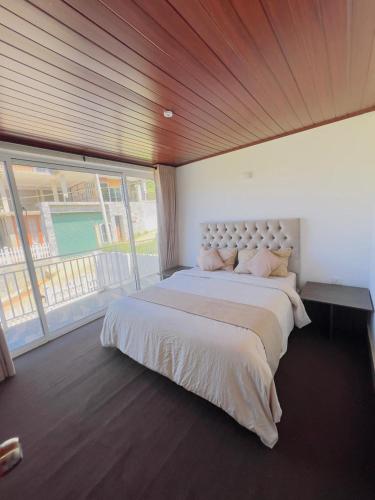 a bedroom with a large bed and a large window at Blackpool Hub in Nikawatawana