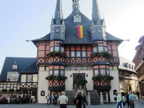 a large building with people standing in front of it at Ferienhaus Wotan in Thale