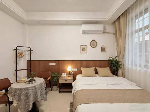 a hotel room with two beds and a desk and a bed at Damao Holiday shanghai pvg 24hFREE shuttle bus in Shanghai