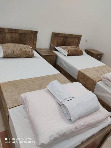 a group of three beds in a room at TOPTEN Hotel Tashkent in Yalanghoch