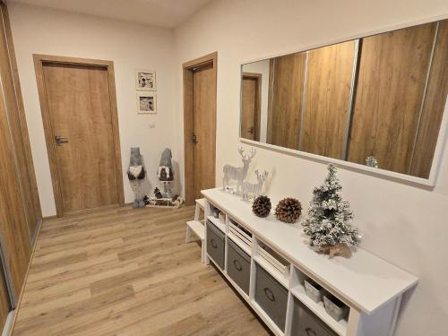 a living room with a christmas tree and a mirror at Apartmán Maršovák Horní Maršov in Horní Maršov