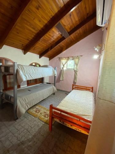 a bedroom with two bunk beds and a window at Casa Mitre en El Paso in Paso de la Patria