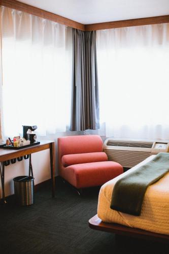 a hotel room with a bed and a chair at Modern Hotel in Boise