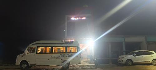 a bus parked in front of a gas station at night at Raghunandan dham in Chitrakoot