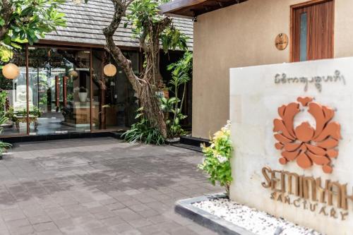 a store with a sign in front of a building at Seminyak Sanctuary Villa by Ini Vie Hospitality in Seminyak