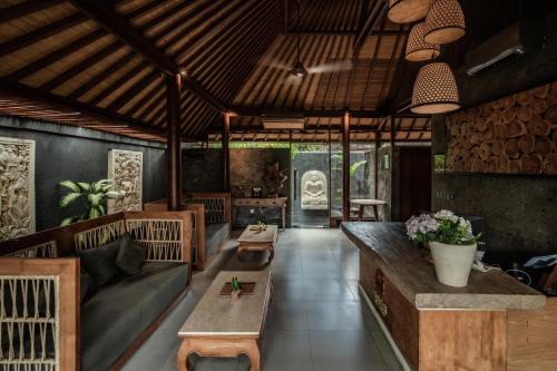 a living room with a couch and a table at Seminyak Sanctuary Villa by Ini Vie Hospitality in Seminyak