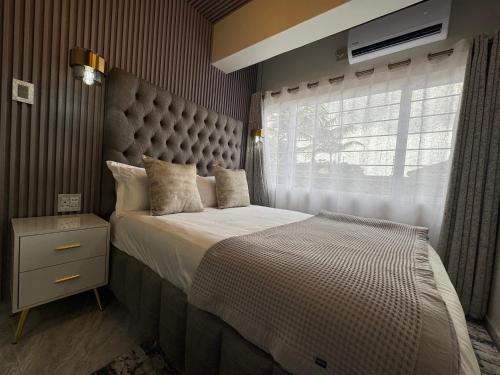 a bedroom with a large bed and a window at G - Boutique in Durban
