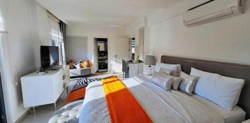 a bedroom with a large bed and a television at Serenity Hideaway Hisarönü in Fethiye