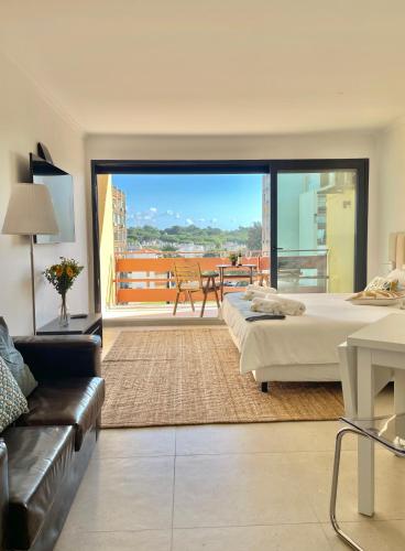 a large living room with a bed and a couch at F&V Studio Vilamoura in Quarteira