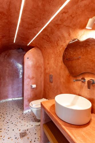 a bathroom with a sink and a toilet at Mardanza Krokos Suites in Imerovigli