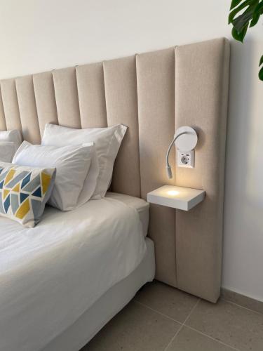 a bedroom with a bed with a lamp on it at F&V Studio Vilamoura in Quarteira