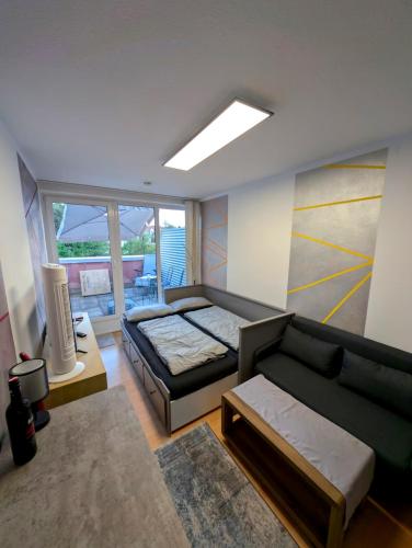 a living room with a bed and a couch at Entspannen in Passau an der Donau inklusive Netflix in Passau