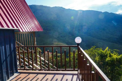 a balcony with a view of a mountain at DreamNest Vagamon in Vagamon