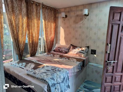 a bedroom with a bed and a window at Swastik Guest House in Arambol