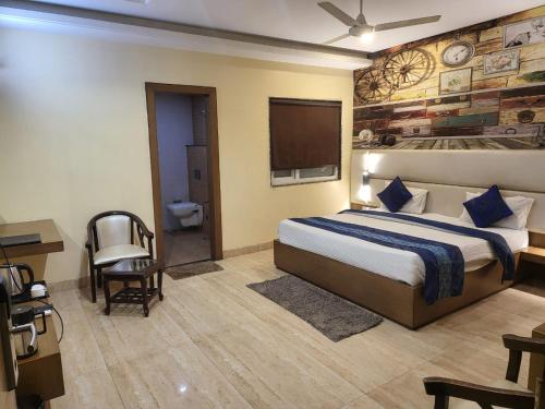 a hotel room with a bed and a television at The Mansion Courtyard in Mathura